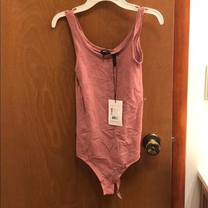 Blush bodysuit. New w tags . Fits like medium